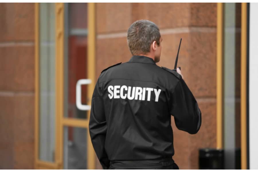 Security guard providing perimeter security for business