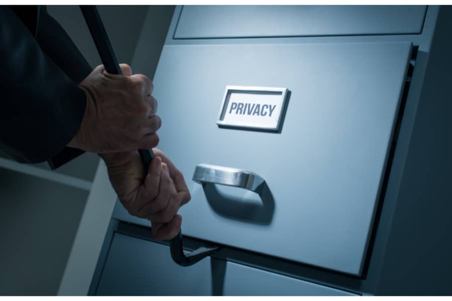 theif using a crowbar to access confidential files in office