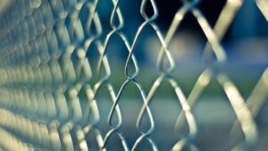 Image of chainlink fence to illustrate risk assessment steps to protect your business in the New Year