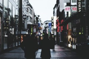 Two people walking down a high street