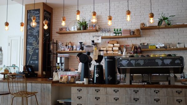 a man behind the desk in a coffee shop