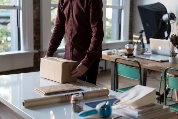 A person going to open a package in the office