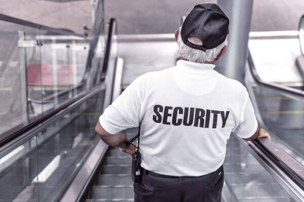A security guard going down an escalator