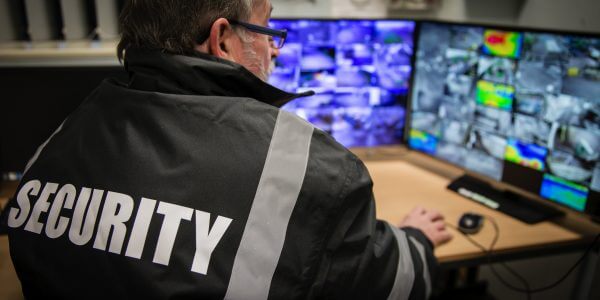 Security man looking at surveillance camera footage