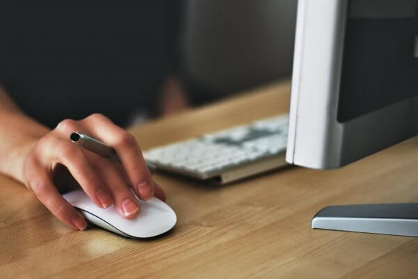 close up of a person's hand on a laptop mouse