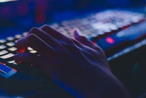 close up of a hand on a computer keyboard to depict a hacker hacking a system to access confidential data
