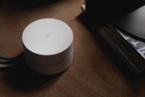 White Google Dot voice activated device which is susceptible to being hacked which can compromise your security