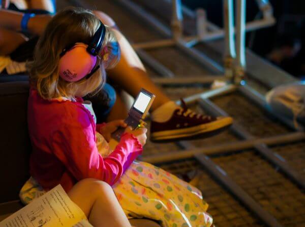 A little girl playing on a game console