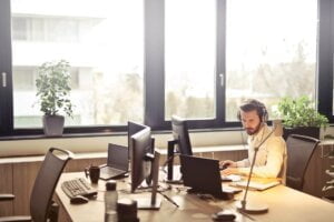 male employee working at a desk to depict whether staff sabotage is part of your security strategy