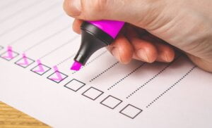 checklist with ticked boxesusing pink marker pen to illustrate whetherI Your business Security is Protecting Your Assets or Just Ticking the Boxes