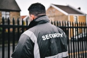 Security Guard Patrolling Perimeter Fencing