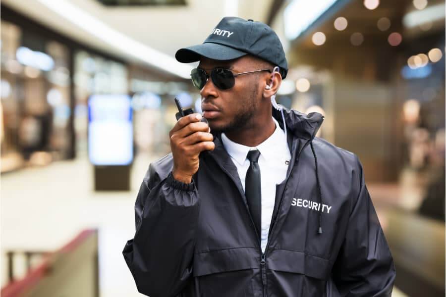 Security guards on radio in large shopping mall