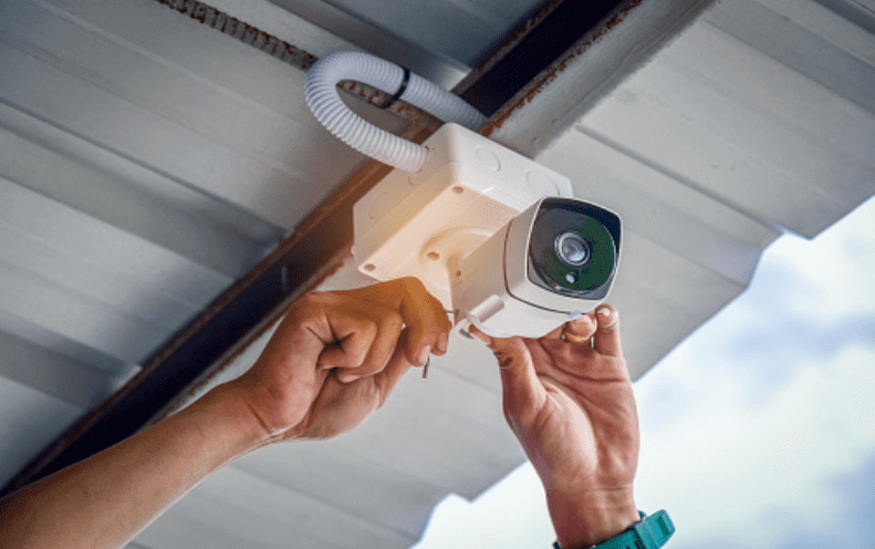 Technician installing CCTV on construction site in South Wales