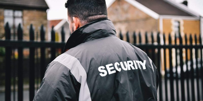 Security Guard Patrolling Perimeter Fencing