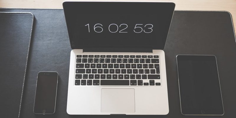 iphone, mac book and ipad on desk to illustrate how such devices can compromise your business and home security