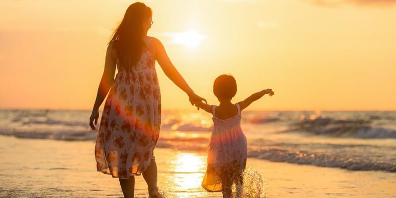 An image of mother and daughter in the sea to support article on how we should explain terrorism to our children