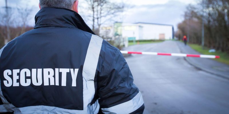 a security officer guarding the premises as part of an emergency security cover strategy
