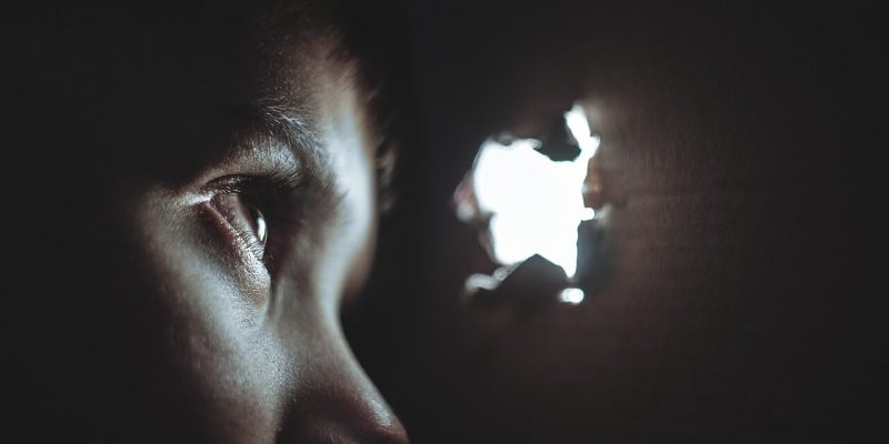 a child looking through a peephole to illustrate hidden threats to your business security that you need to know about